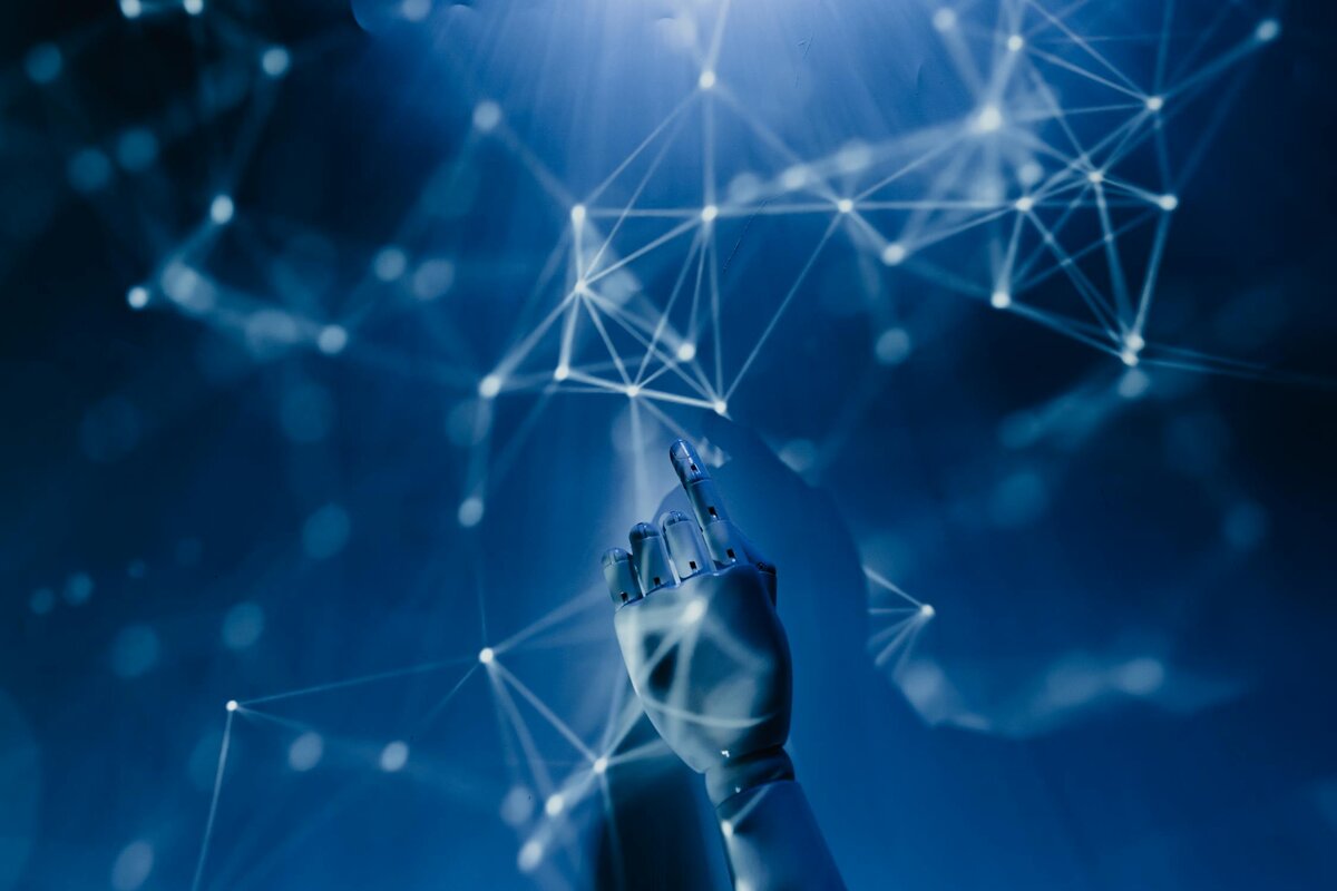 Robotic hand pointing at digital network interface representing marketing automation - Photo by Tara Winstead
