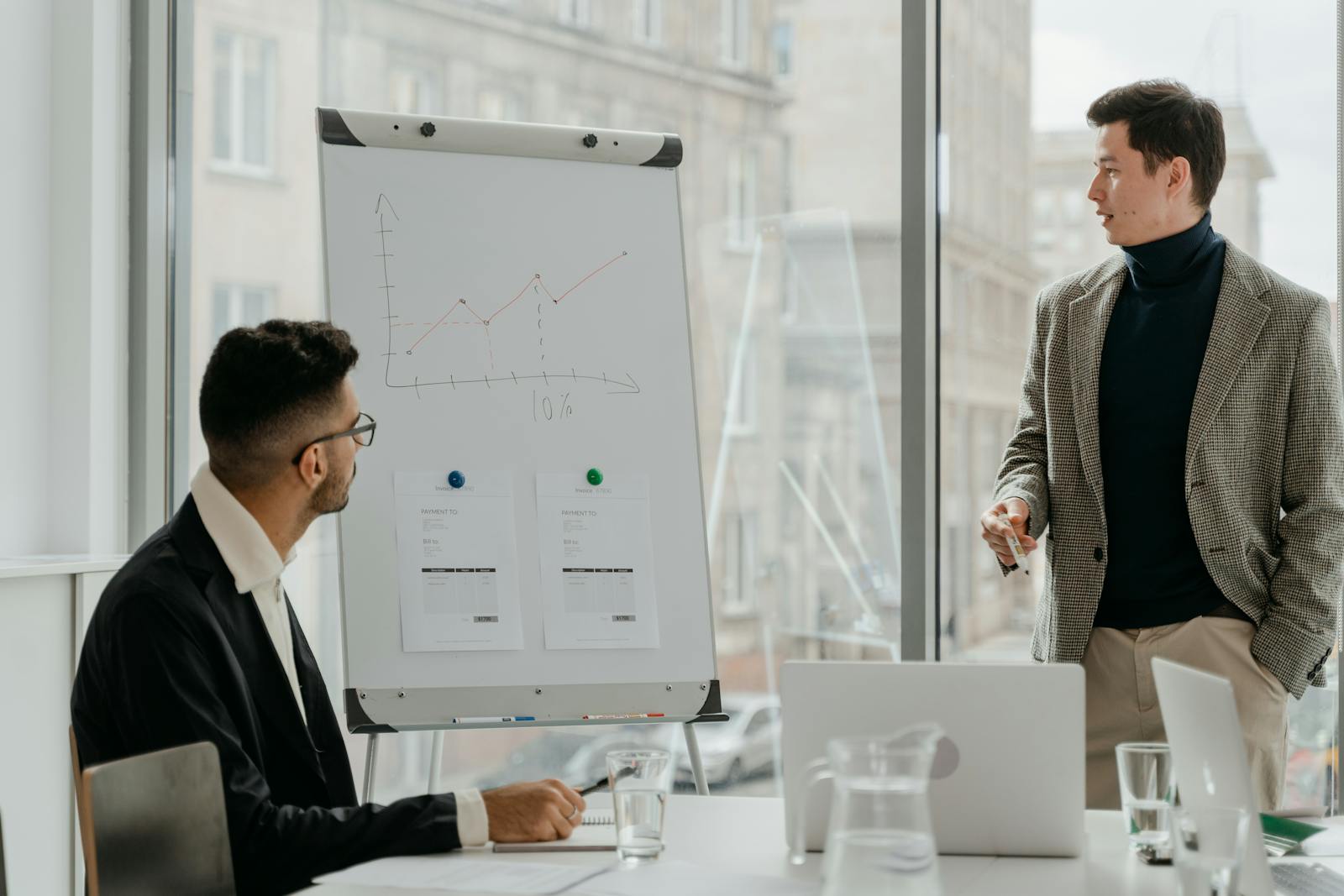Man in Black Suit Jacket Writing on White Board
