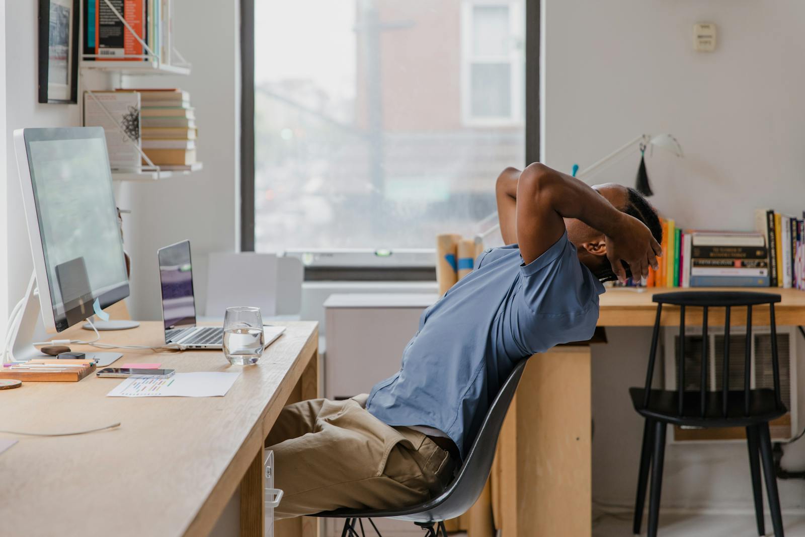 Man with Hands in Hair Sitting in Office