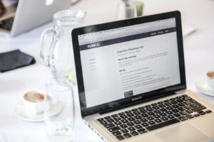 Drinking Glass Beside a Laptop